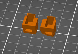 Digitale CAD Vorschau von zwei orangen PS4 Smarttrigger 3D Modellen auf grauem Gitterhintergrund