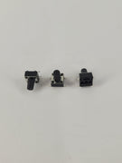 Drei schwarze Kunststoff Taster mit silbernen Metallpins auf weißem Hintergrund
