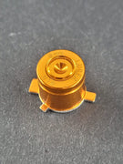 Goldene PS5 X Taste aus Metall im Bullet Design mit 9mm Luger Gravur